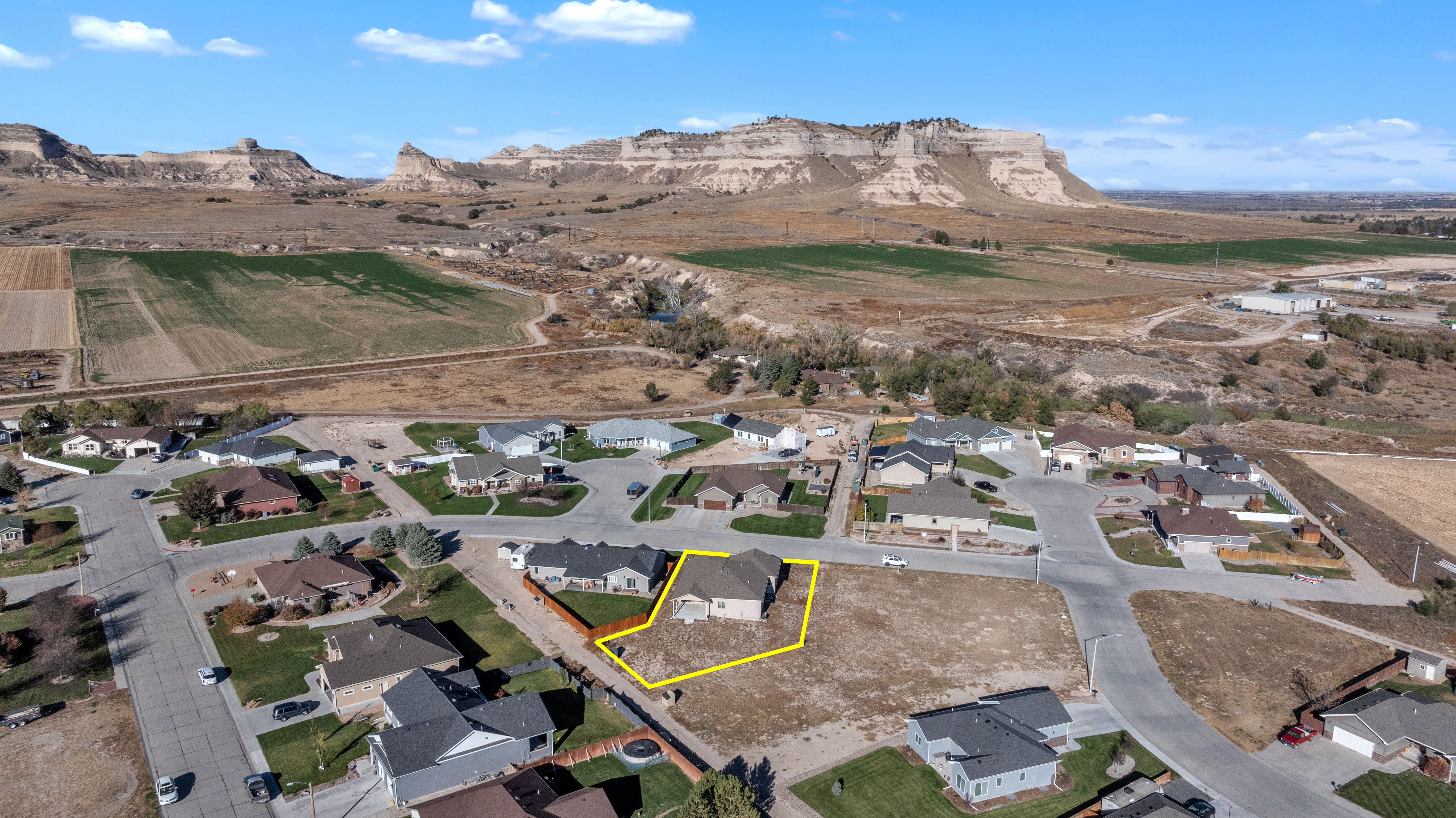 Aerial view of residential property showing lot boundaries and surrounding landscape